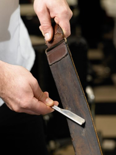 Traditional razor being stropped on leather